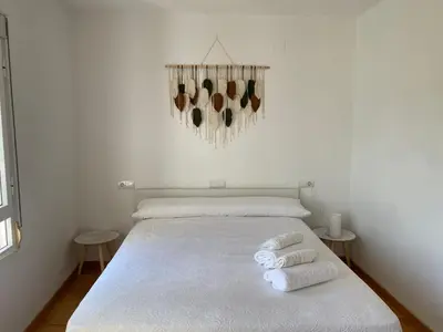 a white bedroom with a bed with towels on it at Casa de la abuela Elisa - Ribeira Sacra - Cañones del Sil - Caurel in Quiroga