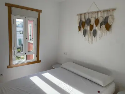 a white bedroom with a bed and a window at Casa de la abuela Elisa - Ribeira Sacra - Cañones del Sil - Caurel in Quiroga