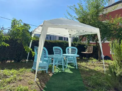 a table and chairs under a white canopy at Casa de la abuela Elisa - Ribeira Sacra - Cañones del Sil - Caurel in Quiroga
