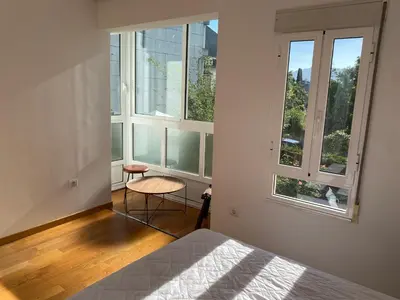 a bedroom with a bed and two large windows at Casa de la abuela Elisa - Ribeira Sacra - Cañones del Sil - Caurel in Quiroga