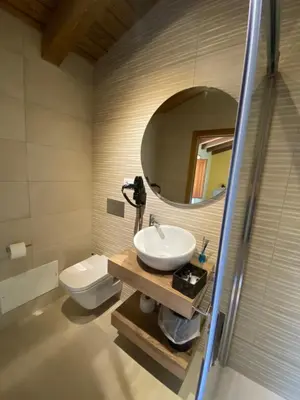 a bathroom with a sink and a toilet and a mirror at Casa da Cota in Monterroso
