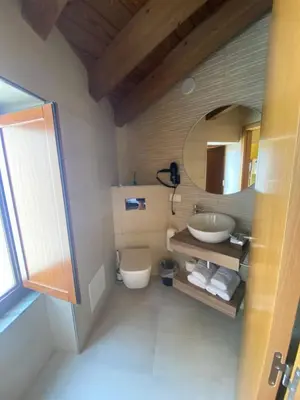 a bathroom with a sink and a toilet and a mirror at Casa da Cota in Monterroso