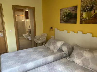 a bedroom with a bed and a bathroom at Casa da Cota in Monterroso