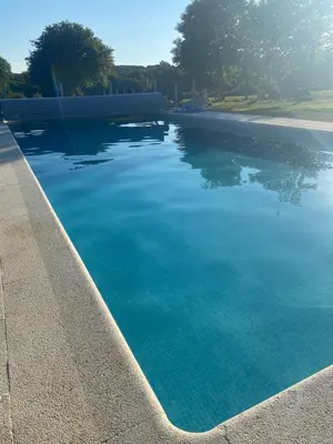 a large swimming pool with blue water at Casa da Cota in Monterroso