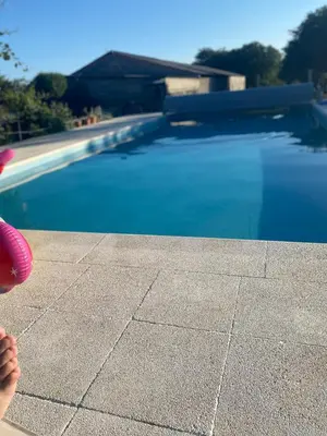 a person is standing next to a swimming pool at Casa da Cota in Monterroso