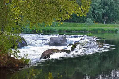 a river with rocks in the middle of the water at Fervenza Casa Grande & Restaurante in Reguengo
