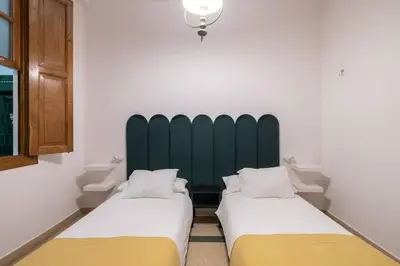 two beds sitting next to each other in a room at Casa Bogart Apto 5 dormitorios in Ourense