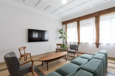 a living room with a couch and a table and chairs at Casa Bogart Apto 5 dormitorios in Ourense