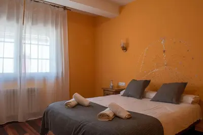 a bedroom with two beds with towels on them at Hostal Galicia in Monforte de Lemos