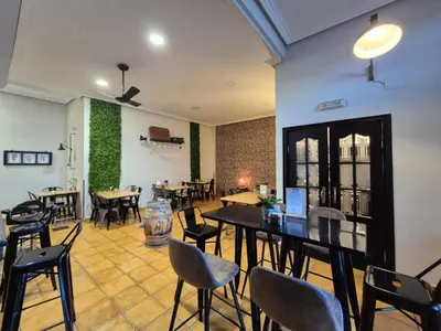 a restaurant with tables and chairs in a room at Hostal Galicia in Monforte de Lemos