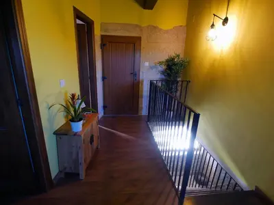a hallway with a stairway with a door and a stair case at ACASADOCRUCEIRO in Vales