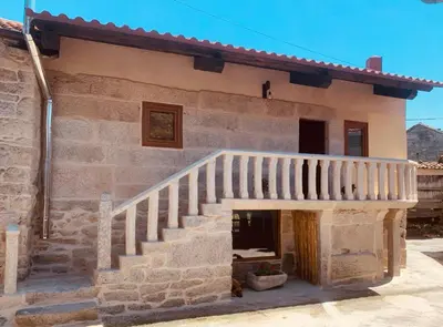 a stone house with a staircase in front of it at ACASADOCRUCEIRO in Vales
