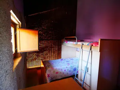 a room with two bunk beds and a window at ACASADOCRUCEIRO in Vales
