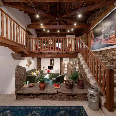 a living room with a couch and a staircase at A Casacuberta in Marquiño