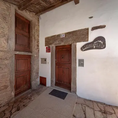 a entrance to a building with a wooden door at A Casacuberta in Marquiño