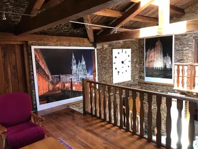a room with paintings on the walls and a purple chair at A Casacuberta in Marquiño