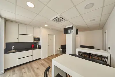 a kitchen and dining room with a table and chairs at ALBERGUE SEGUE O CAMIÑO in Sigüeiro