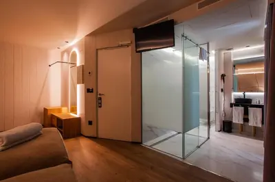 a living room with a glass door and a couch at Hotel Plaza Obradoiro by Bossh! Hotels in Santiago de Compostela