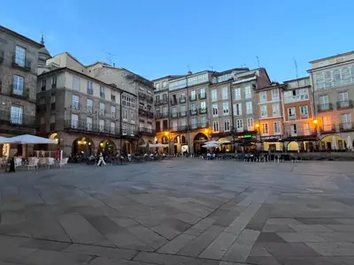 a city square with buildings and tables and chairs at Apartamento Cervantes in Ourense