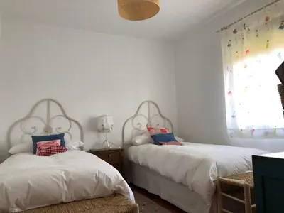 a bedroom with two beds and a window at Apartamentos Montemar in Navia