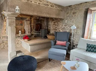 a living room with a couch and a chair at A Casa do Portal, tu casa rural en Campo Lameiro, cerca de Pontevedra in Campo Lameiro