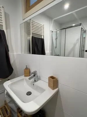 a white bathroom with a sink and a mirror at A Casa do Portal, tu casa rural en Campo Lameiro, cerca de Pontevedra in Campo Lameiro