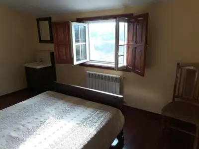 a bedroom with a bed and a window at Casa Rural A Telleira in A Estrada