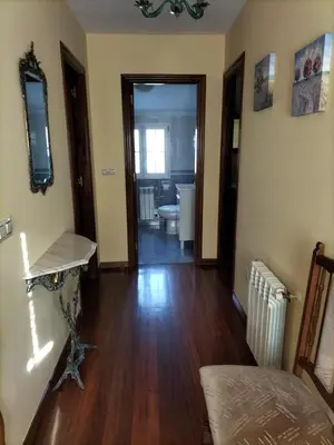 a living room with a hard wood floor and a hallway at Casa Rural A Telleira in A Estrada