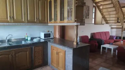 a kitchen with a sink and a living room at Casa Rural A Telleira in A Estrada