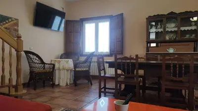 a living room with a dining room table and chairs at Casa Rural A Telleira in A Estrada