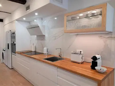a kitchen with a wooden counter top and a sink at Apartamento con encanto en centro histórico Lugo -TineriaLucusHome in Lugo