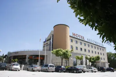 a hotel with cars parked in front of it at Hotel Alfonso IX in Sarria