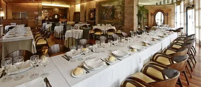 a large dining room with white tables and chairs at Hotel Alfonso IX in Sarria