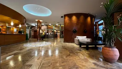 a lobby of a hotel with a couch and a table at Hotel Alfonso IX in Sarria