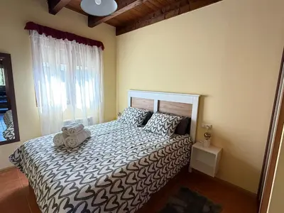 a bedroom with a bed with a teddy bear on it at Villa Quijada in Trefacio