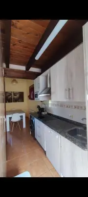 a kitchen with white cabinets and a counter top at Villa Quijada in Trefacio