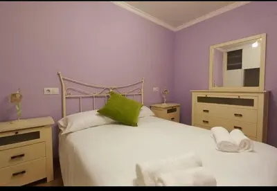 a small bedroom with two beds and a mirror at Corazón de Lemos in Monforte de Lemos