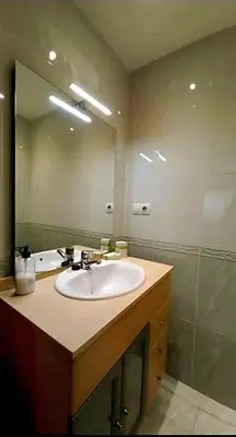 a bathroom with a sink and a large mirror at Corazón de Lemos in Monforte de Lemos