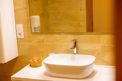 a bathroom with a white sink and a mirror at APARTAMENTOS RIAMAR 2 in Ribadeo
