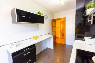 a kitchen with a counter with a tv on the wall at APARTAMENTOS RIAMAR 2 in Ribadeo