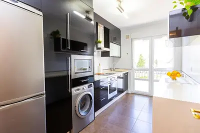 a kitchen with a washer and dryer in it at APARTAMENTOS RIAMAR 2 in Ribadeo