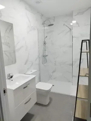 a white bathroom with a toilet and a shower at HORIZON in Arzúa