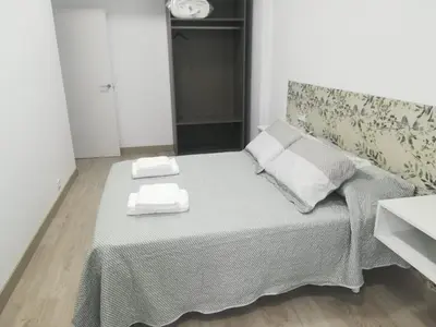a bedroom with a bed with two towels on it at HORIZON in Arzúa