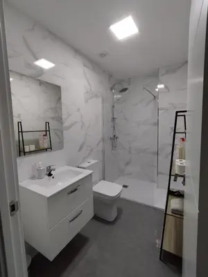 a bathroom with a toilet and a sink and a shower at HORIZON in Arzúa