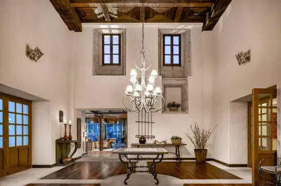 a dining room with a table and a chandelier at Hotel Palacio del Carmen, Autograph Collection in Santiago de Compostela