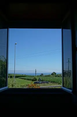 an open window with a view of the ocean at Casa Gayol in El Franco