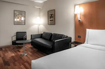 a hotel room with a couch and a bed at AC Hotel Ponferrada by Marriott in Ponferrada