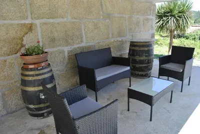 a group of chairs and tables on a patio at Casa da Buxeira . Entorno magico. in Caritel