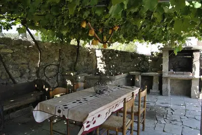 a table and chairs with a table and a fireplace at Casa da Buxeira . Entorno magico. in Caritel