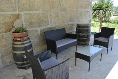 a group of chairs and tables on a patio at Casa da Buxeira . Entorno magico. in Caritel